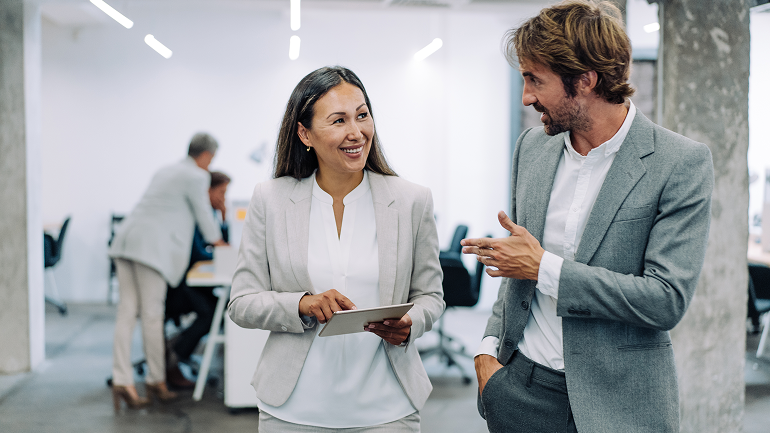 Two insurance professionals discussing the claims process and providing guidance after filing an insurance claim.