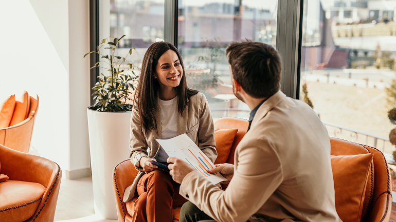 Insurance advisor discussing how rising costs affect insurance cover during a client consultation.